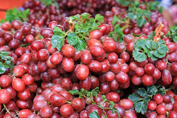 Close-up red wine grapes fruit background at local market.