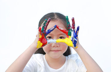 Adorable little girl looking through her triangle colorful hands painted over white background.