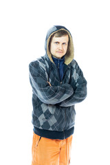a young man in a jacket and orange pants looks at the camera. Isolated