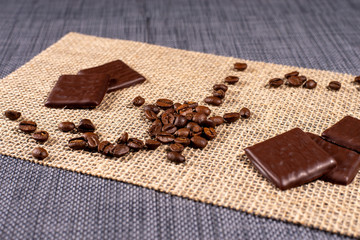 coffee beans and chocolate on burlap background