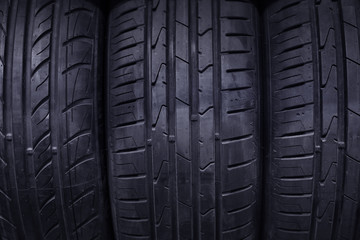 Seasonal tire storage background with tyres close-up