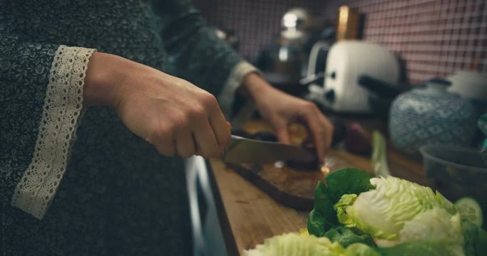 Young pregnant woman making a salad
