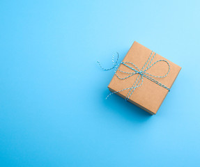 brown square box with a gift tied rope on a blue background
