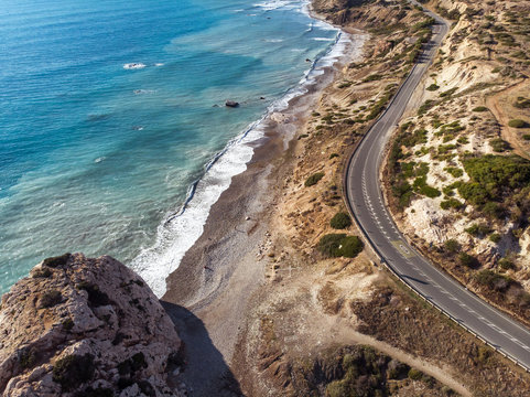 Aerial view of road going along the mountain and ocean or sea. Drone photography from above