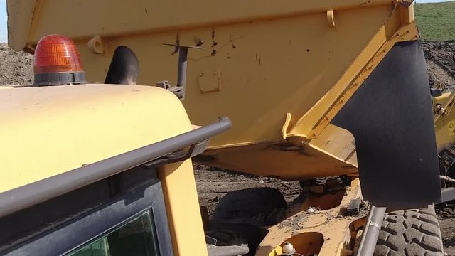 Action cam shot of a dumper truck tipping earth .