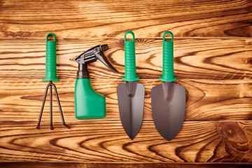 Gardening tools on wooden background flat lay