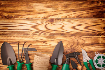 Gardening tools on wooden background flat lay