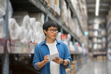 Portrait Asian men, staff, product counting Warehouse Control Manager Standing, counting and inspecting products in the warehouse