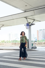 Obraz premium Happy business woman is traveling with luggage in airport
