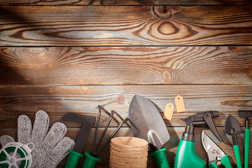 Gardening tools on wooden background flat lay