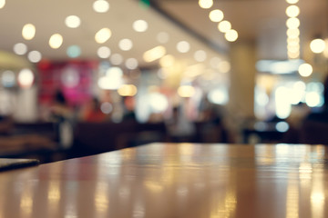 wooden table empty of display in cafe with luxury light decoration