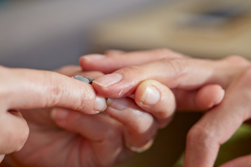 Nail care service at salon, removing cuticle with nail nipper 