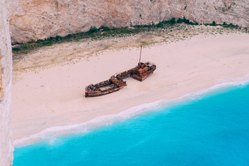 An old rusted ship, wrecked, lies on the seashore. Navagio Bay Shipwreck Beach Greece, Zakynthos