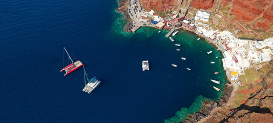 Aerial drone ultra wide photo of small picturesque harbour of Ammoudi below iconic village of Oia, Santorini island, Cyclades, Greeceaegean, aerial, ammoudi, amoudi, amoudi bay, architecture, bay, bea