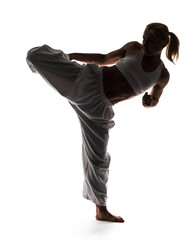 Karate woman posing standing on one leg