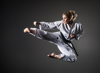 Composite image of karate girl jumping © YouraPechkin