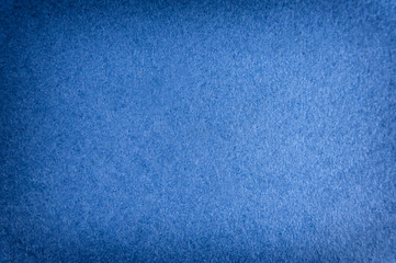 Navy blue matte background of suede fabric, closeup. Velvet texture of seamless woolen felt