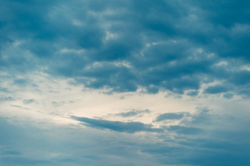 Naklejka na ściany i meble Blue sky with floating white clouds. The background.