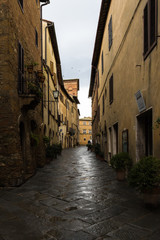 Cityscape with a narrow street among the medieval houses after the rain.