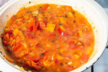 Cooking delicious homemade tomato, onion and carrot sauce