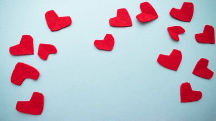 Valentine's day background. Red hearts on a blue background.