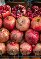 fresh pomegranate fruits lie on the display case