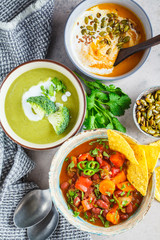 Set of vegan soups. Mexican bean soup, broccoli cream soup and mashed pumpkin soup, top view.