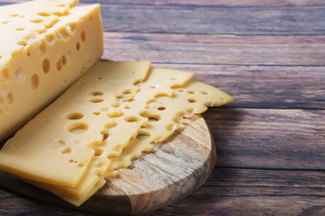 sliced cheese on a chopping wooden board