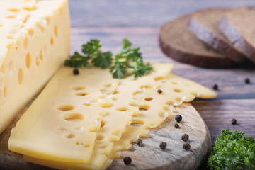 sliced cheese on a chopping wooden board