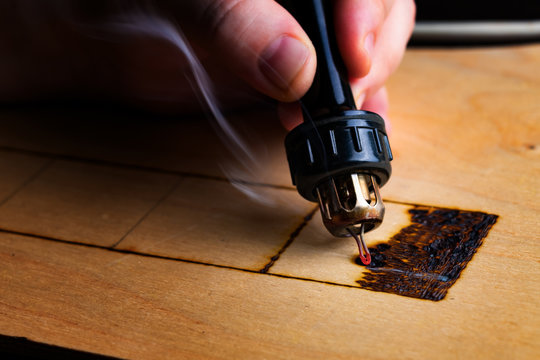 Pyrography. Wood burning with pyrography pen. Close up