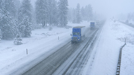 Trucks haul containers across the state of Washington and through a snowstorm.