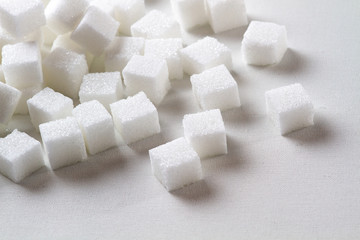 high key Closeup of a Pile of sugar cubes randomly arranged on a white background