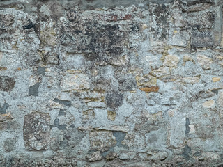wall of large multicoloured exposed stones in grey cement all around
