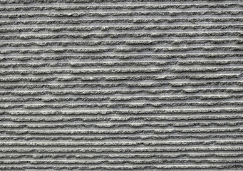 close-up pattern of a concrete wall with broad horizontal lines exposed