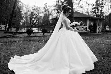 Beautiful wedding bouquet with fresh flowers on a wedding day. Wedding. Beautiful bride. Girl holding flowers in hands, young beautiful bride in white dress. Beauty, fashion