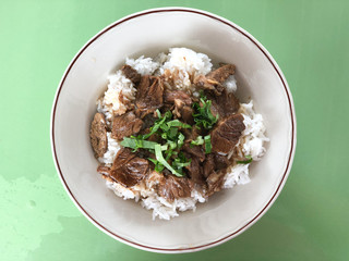 Stewed beef on rice in white dish