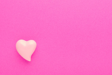 pink background with a heart and with copy space