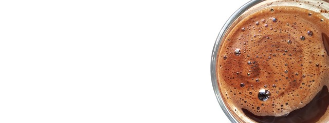 Coffee mug with brown foam inside and a white background for the text. White empty space for your design. Top view coffee.