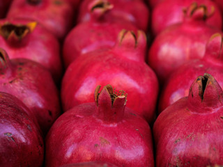 Red ripe pomegranate fruit lie in a box