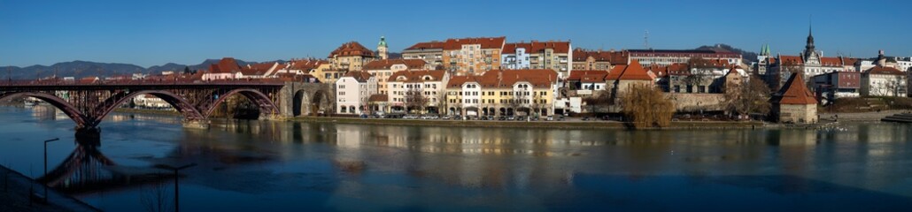 Picturesque landscape of old part of the city Maribor. Old Bridge and Water Tower reflected in Drava River