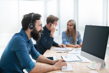 business man in a headset sitting at the office table