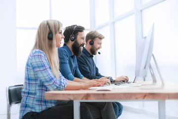 group of call center employees working on modern computers
