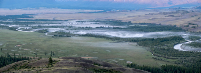 Morning fog on the river, Chuy valley in the summer. Mountain Altai, panorama.