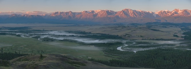 Morning fog on the river, Chuy valley in the summer. Sunrise over the North Chuysky ridge. Mountain Altai, panorama.