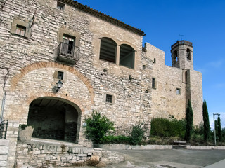 Fototapeta na wymiar Spain, Montfalco Murallat - October 10, 2018: Arched entrance to Montfalco Murallat mediaeval village-fortress (Lleida), outside view. Tourist place in Catalonia with ancient stone walls and a chapel