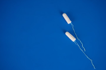 Health care and medicine - tampons on blue background.