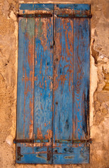 A colourful wooden shuttered window on a building in Provence France