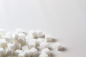 Fototapeta na wymiar high key Closeup of a Pile of sugar cubes randomly arranged on a white background