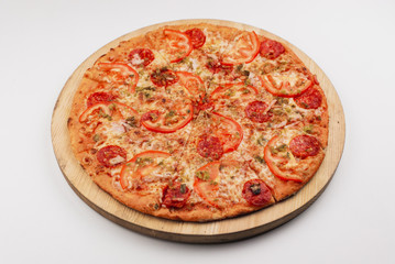 Pizza with ham, olives and cheese served on wooden plate