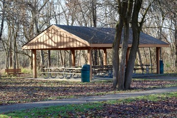 The empty picnic shelter in the woods of the park.